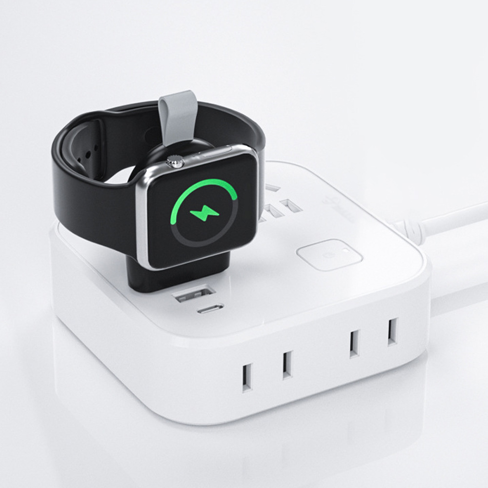 Apple Watch, die auf einem schwarzen USB-Gerät aufgeladen wird, das an eine weiße Steckdosenleiste angeschlossen ist.