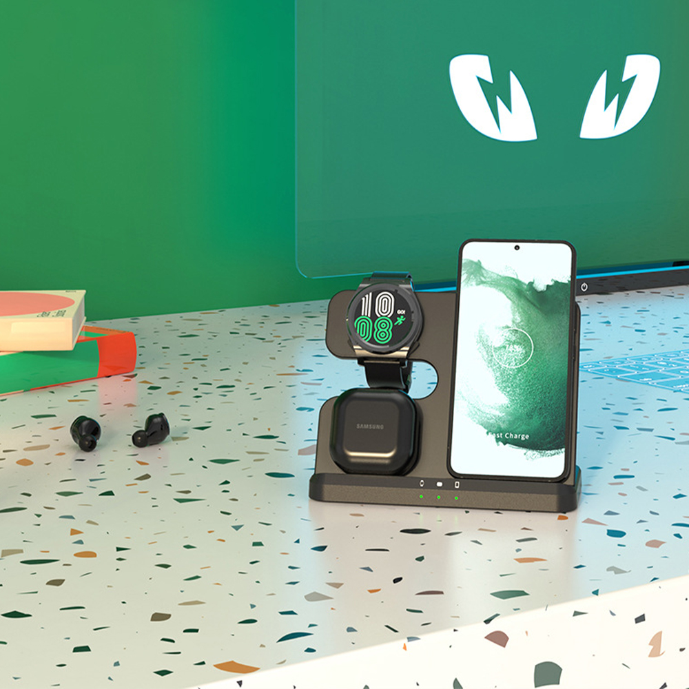 Eine Ladestation mit einem Telefon, einer Uhr und Ohrhörern auf einer farbenfrohen Oberfläche.