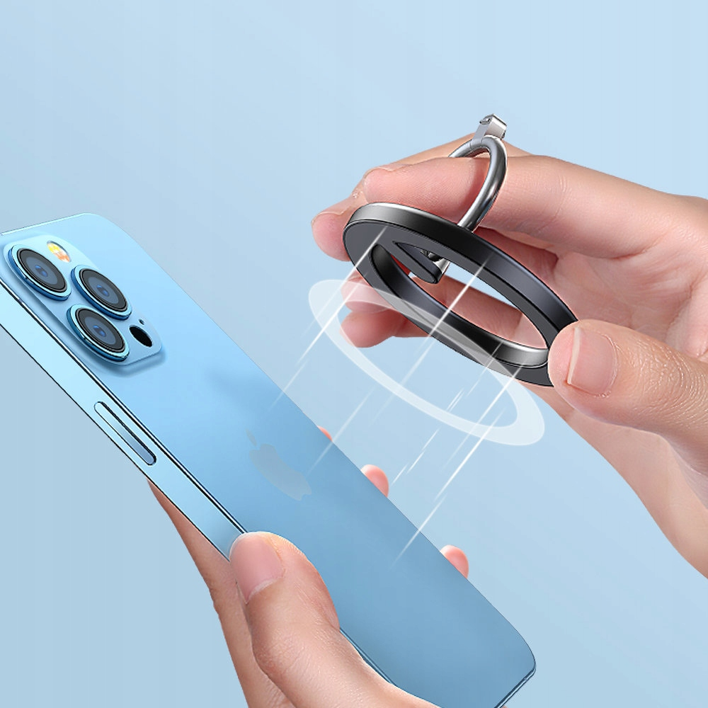Osoba trzymająca telefon i pierścień magnetyczny. Pierścień przymocowuje się do tyłu telefonu.