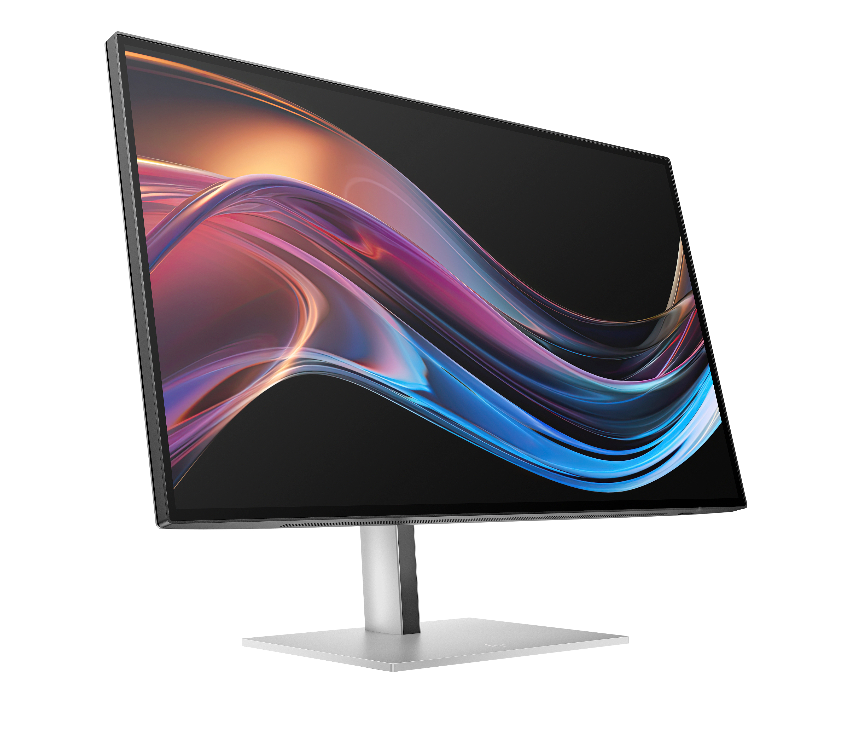 Un monitor que muestra un diseño abstracto colorido sobre fondo negro, vista en ángulo.