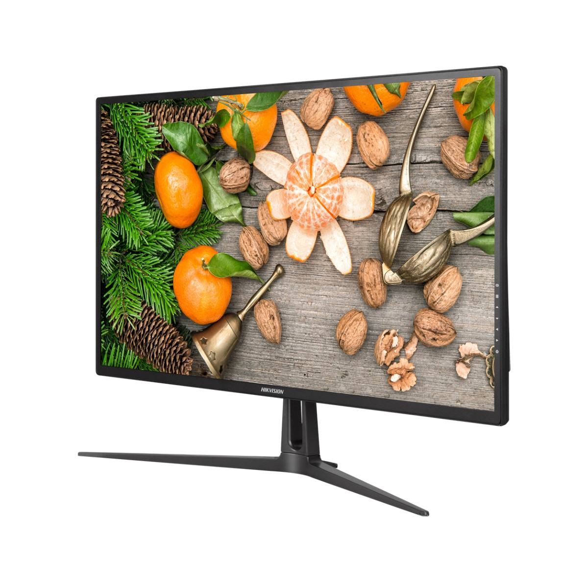 Monitor con fondo de madera, naranjas, nueces y una campana.