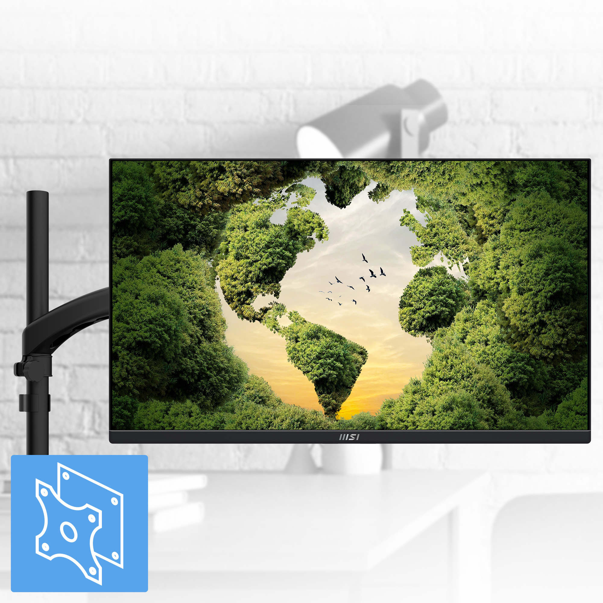 Czarny monitor wyświetla las w kształcie Ziemi z ptakami. Jest zamontowany na czarnym ramieniu na tle ceglanej ściany.