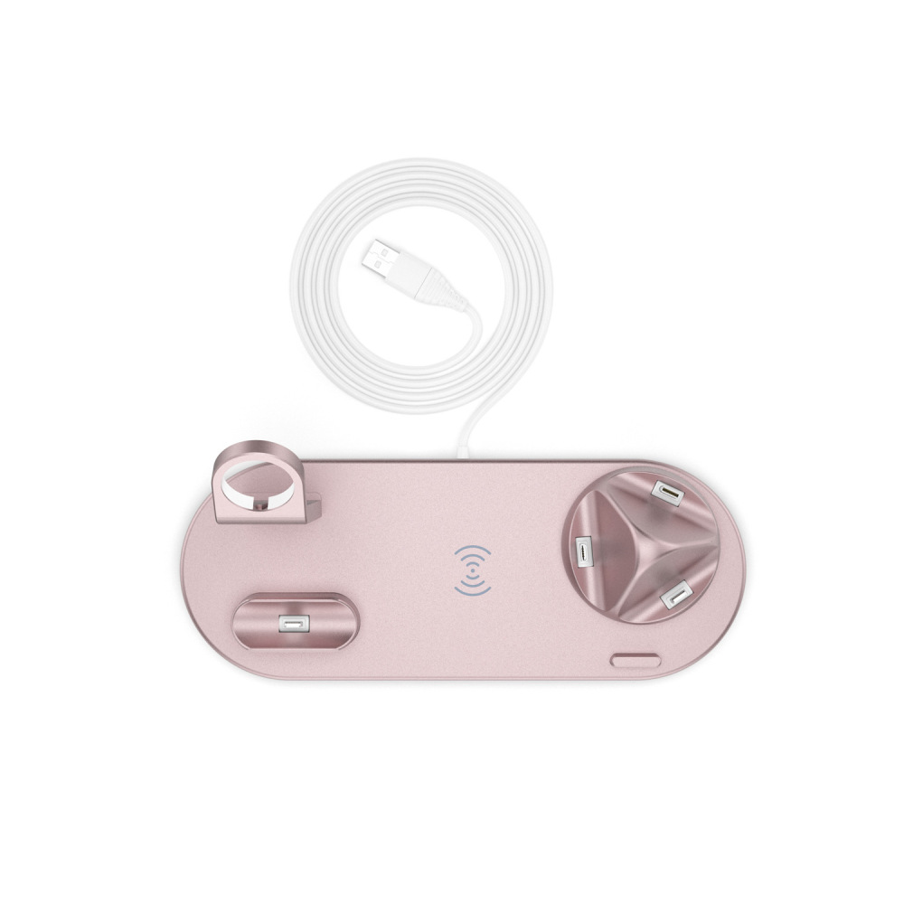Ein roségoldener Ladeständer und ein USB-Kabel, von oben vor einem weißen Hintergrund gesehen.