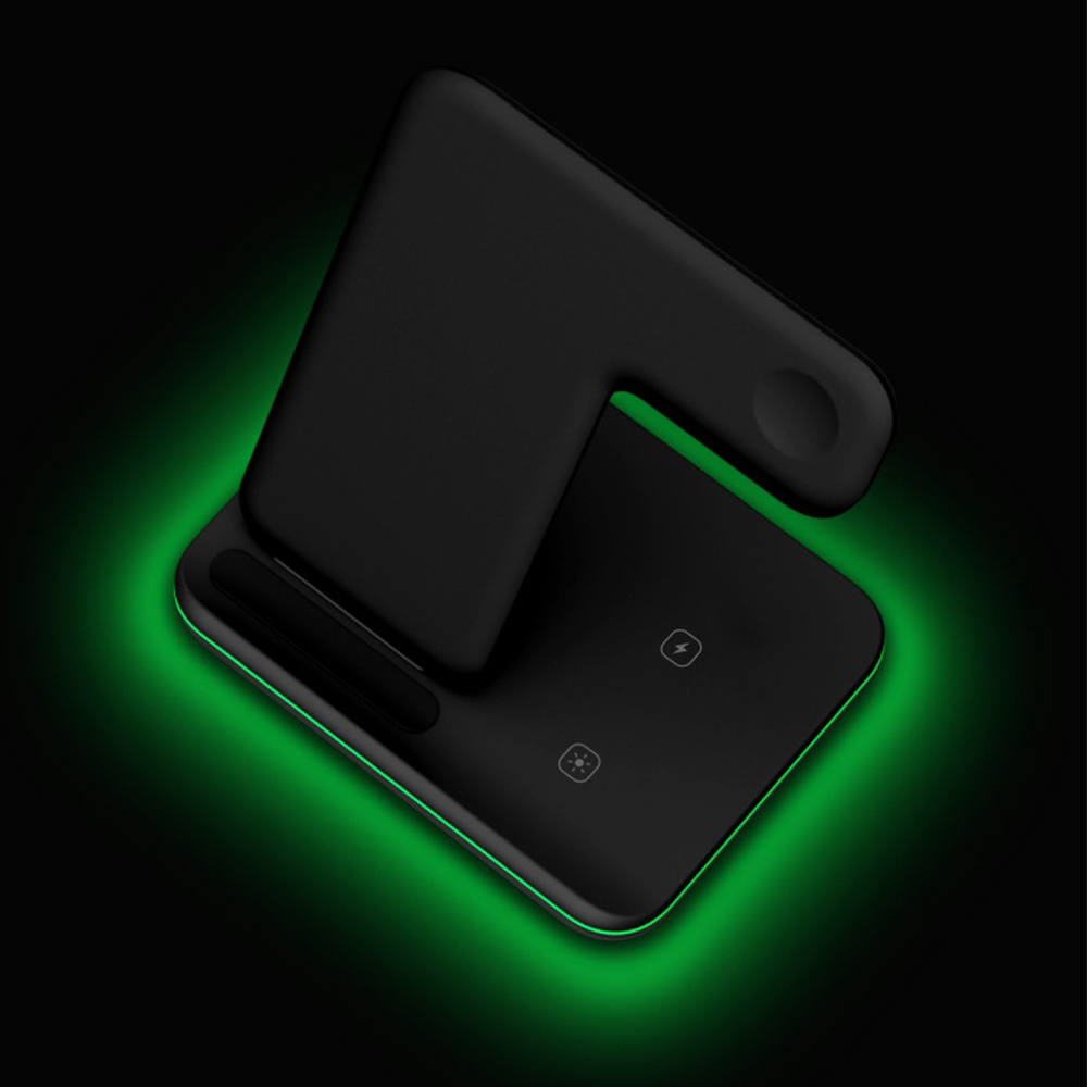 Ein schwarzer kabelloser Ladeständer für Handy, Uhr und Ohrhörer, der grün leuchtet.