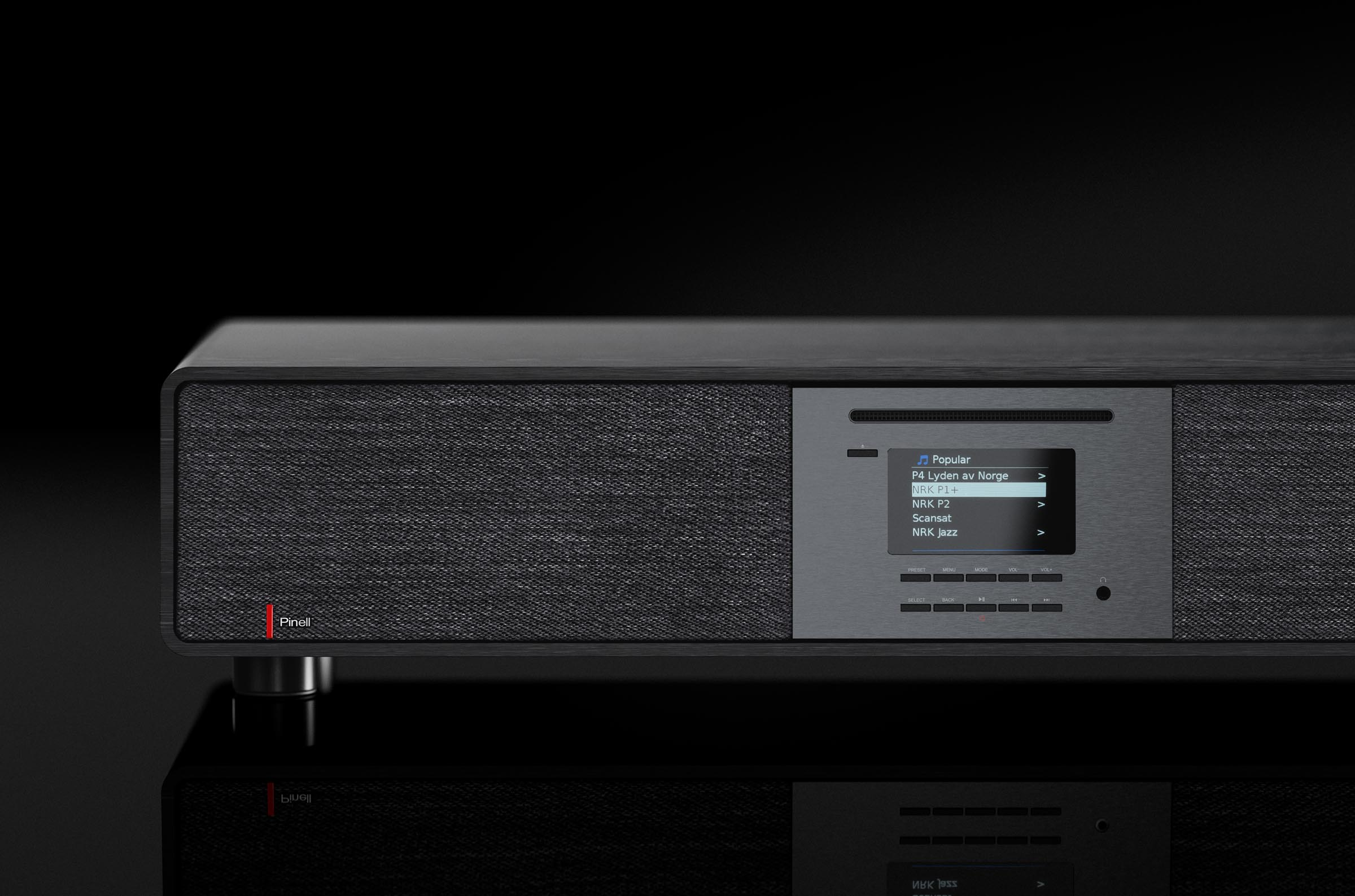 A black audio device with display, showing radio options, on a reflective surface against a black backdrop.