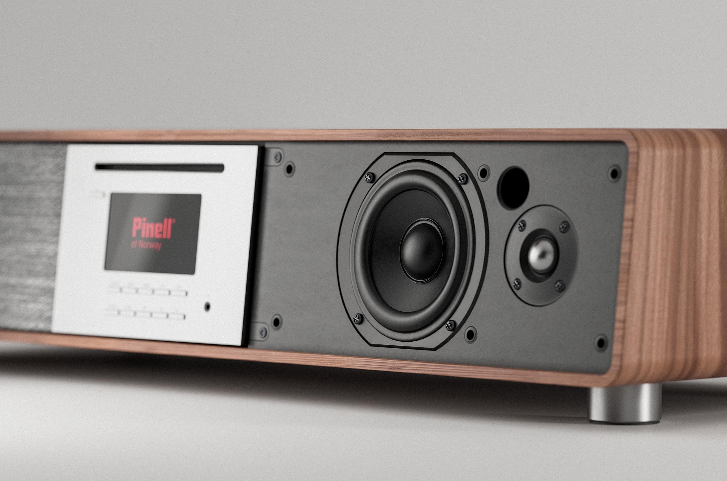 Wooden stereo system with a screen displaying 'Pinell', black speaker and a CD slot.