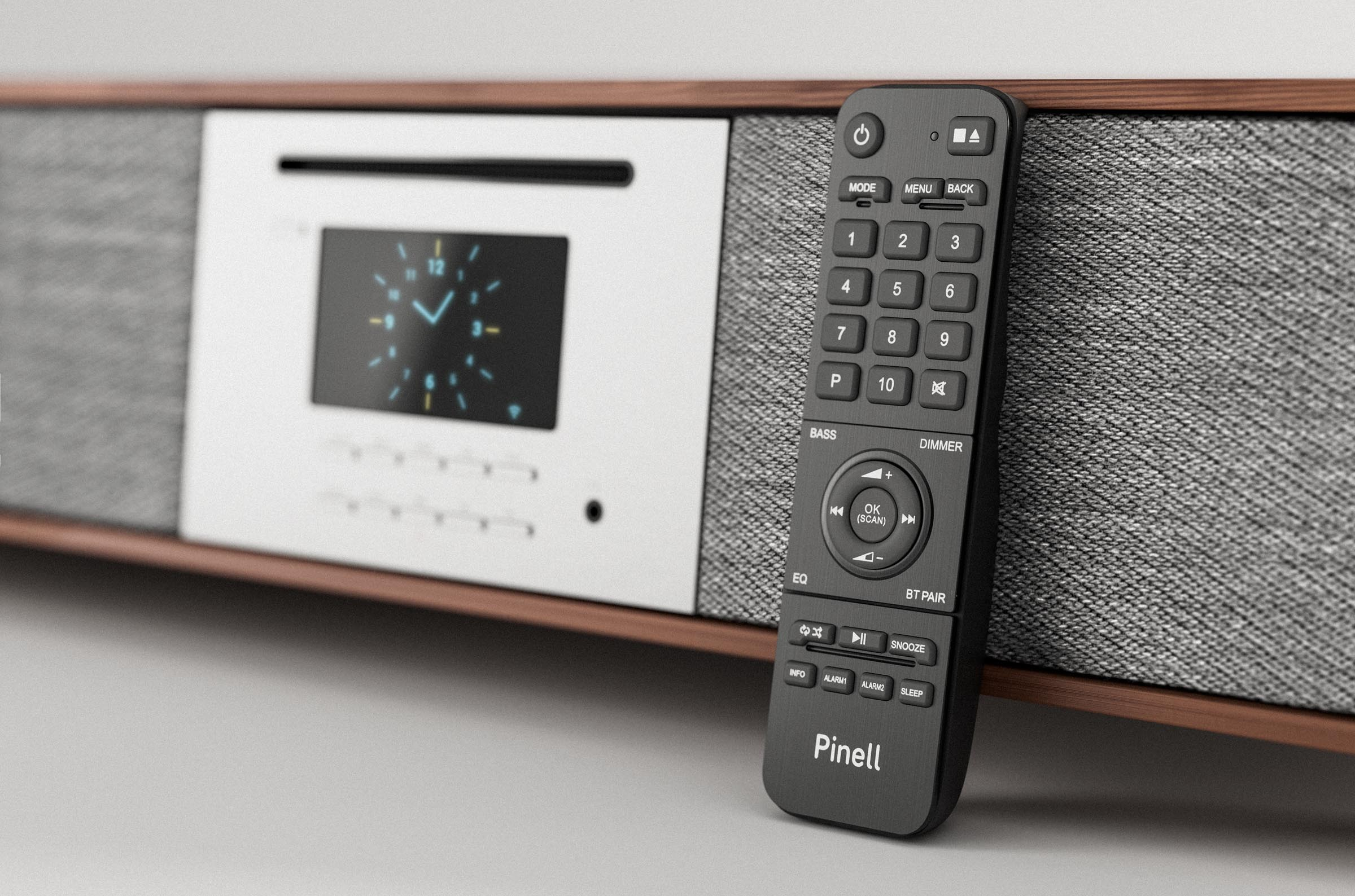 Stereo system with a remote control. The screen shows a clock. The remote has buttons.