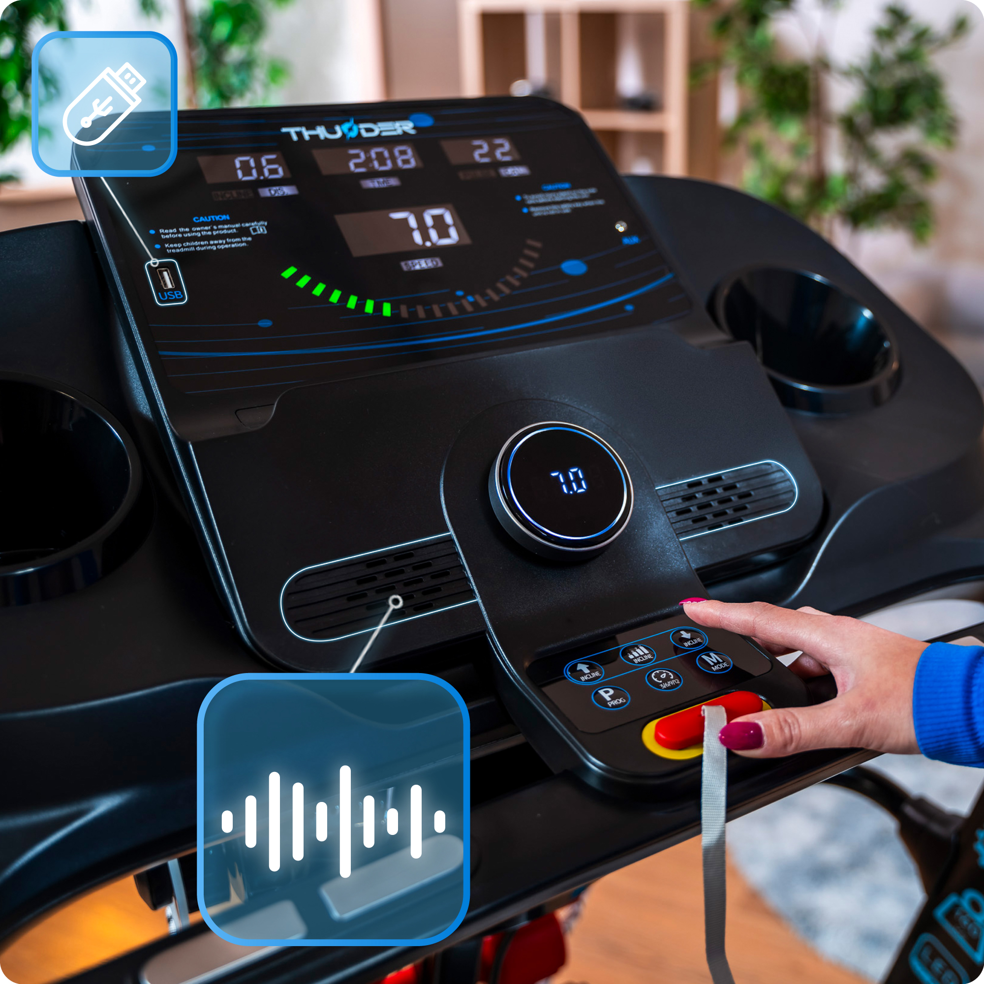 Ręka reguluje konsolę czarnej bieżni z dołączonym czerwonym kluczem bezpieczeństwa.