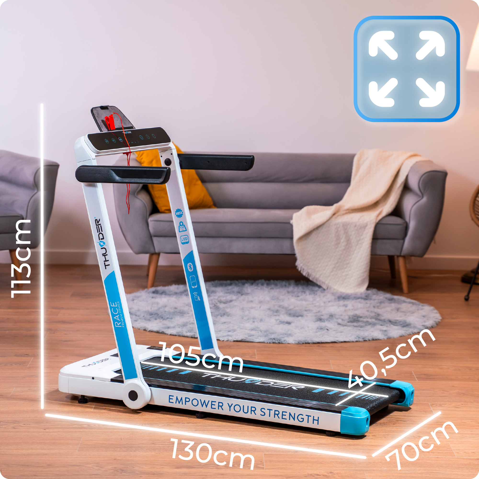 Biała i niebieska bieżnia z pokazanymi wymiarami. Rozwiń ikonę w górnym rogu.