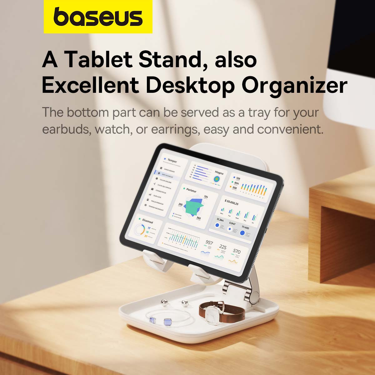 Stojak na tablet Baseus trzyma tablet wyświetlający wykresy, nad tacką z akcesoriami na drewnianym stole.