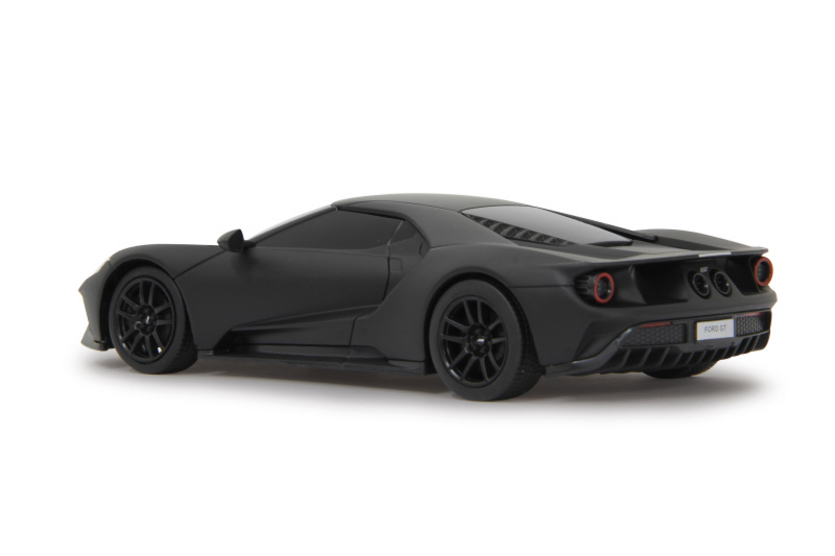 Ein mattes schwarzes Spielzeugauto wird von hinten auf einem weißen Hintergrund gezeigt.