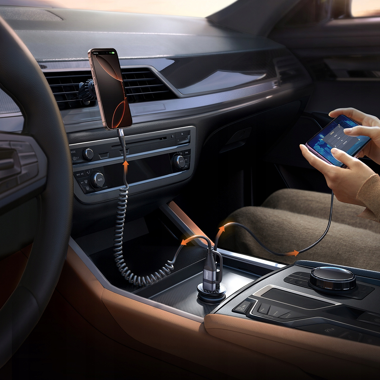 Telefon ładuje się w samochodzie. Inny telefon jest trzymany przez osobę, która również się ładuje.