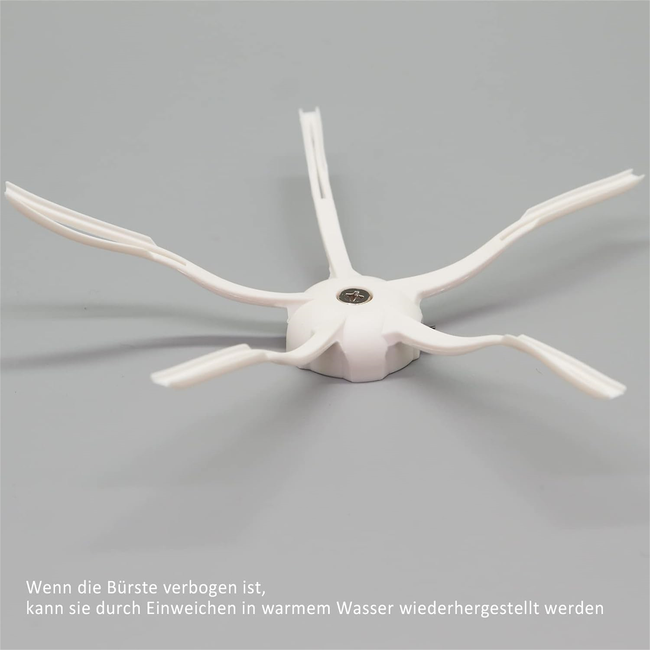 Weißer, sternförmiger Roboter-Staubsauger-Bürste mit mehreren Armen.