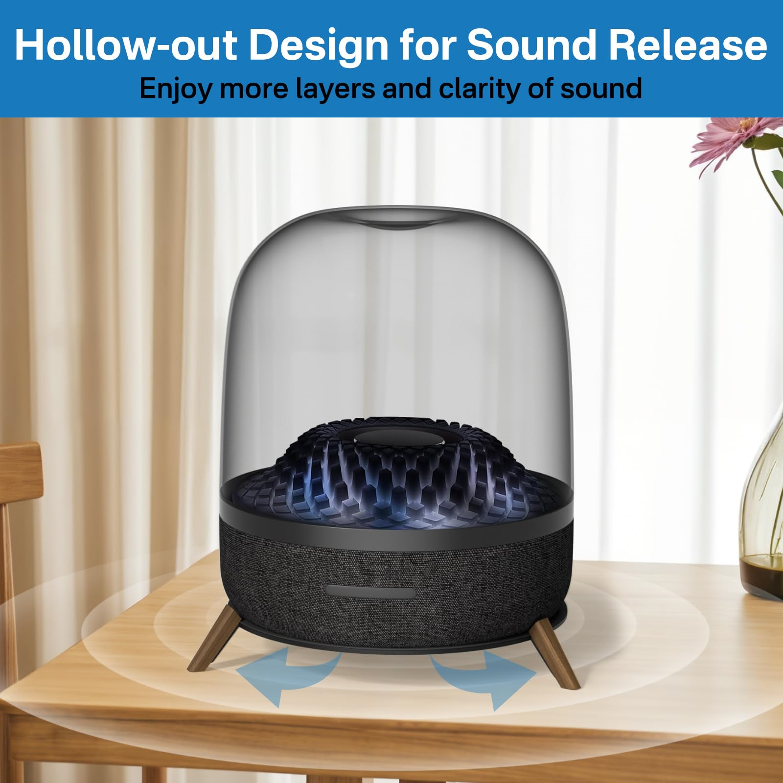 Harman Kardon Aura Studio Lautsprecher mit Hohlraumdesign auf einem Holztisch.