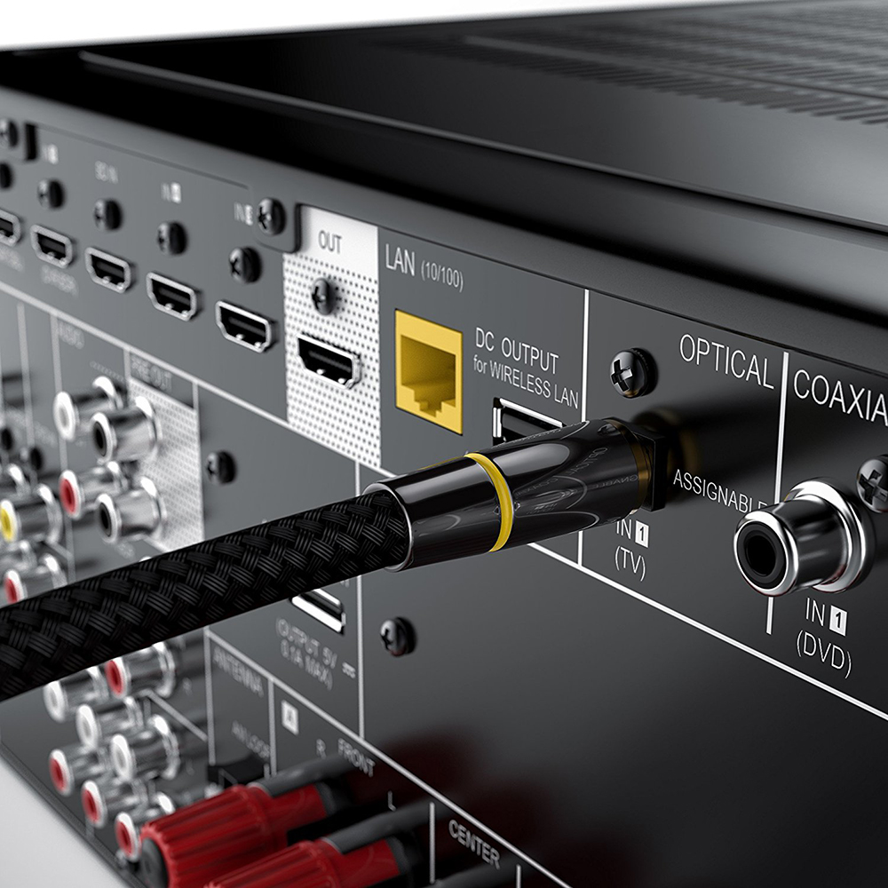 Nahaufnahme der Rückseite eines schwarzen AV-Receivers, mit Kabeln, die in die Anschlüsse gesteckt sind. Gelber LAN-Anschluss sichtbar.