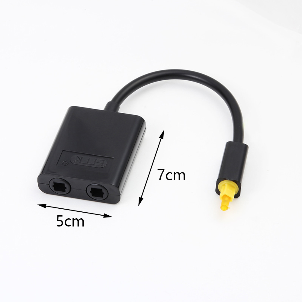 Ein schwarzer Adapter mit einem gelben optischen Anschluss auf weißem Hintergrund, mit Maßangaben zur Größenangabe.
