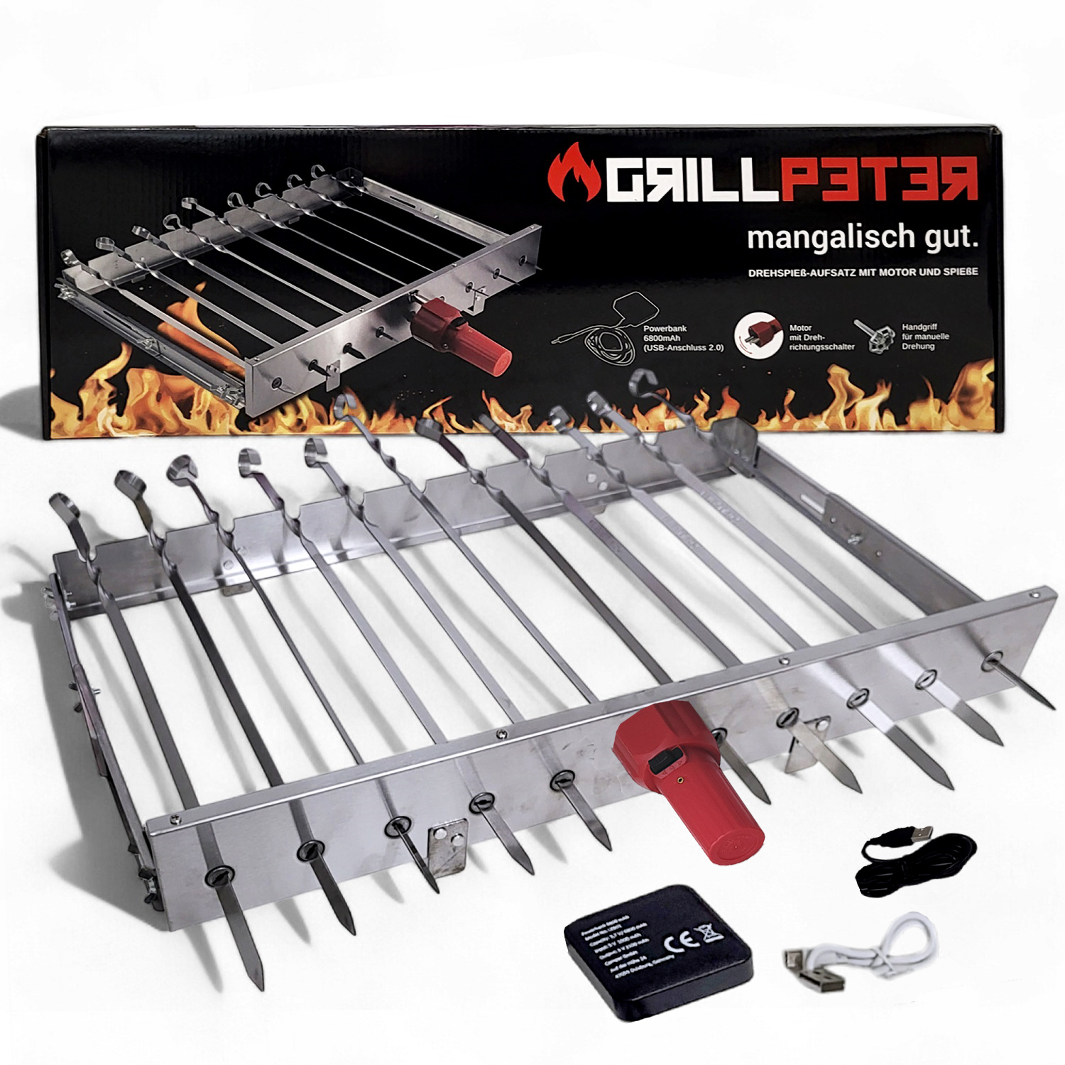 Ein Metallgrill mit Spießen, einem roten Griff und einer Kiste im Hintergrund.
