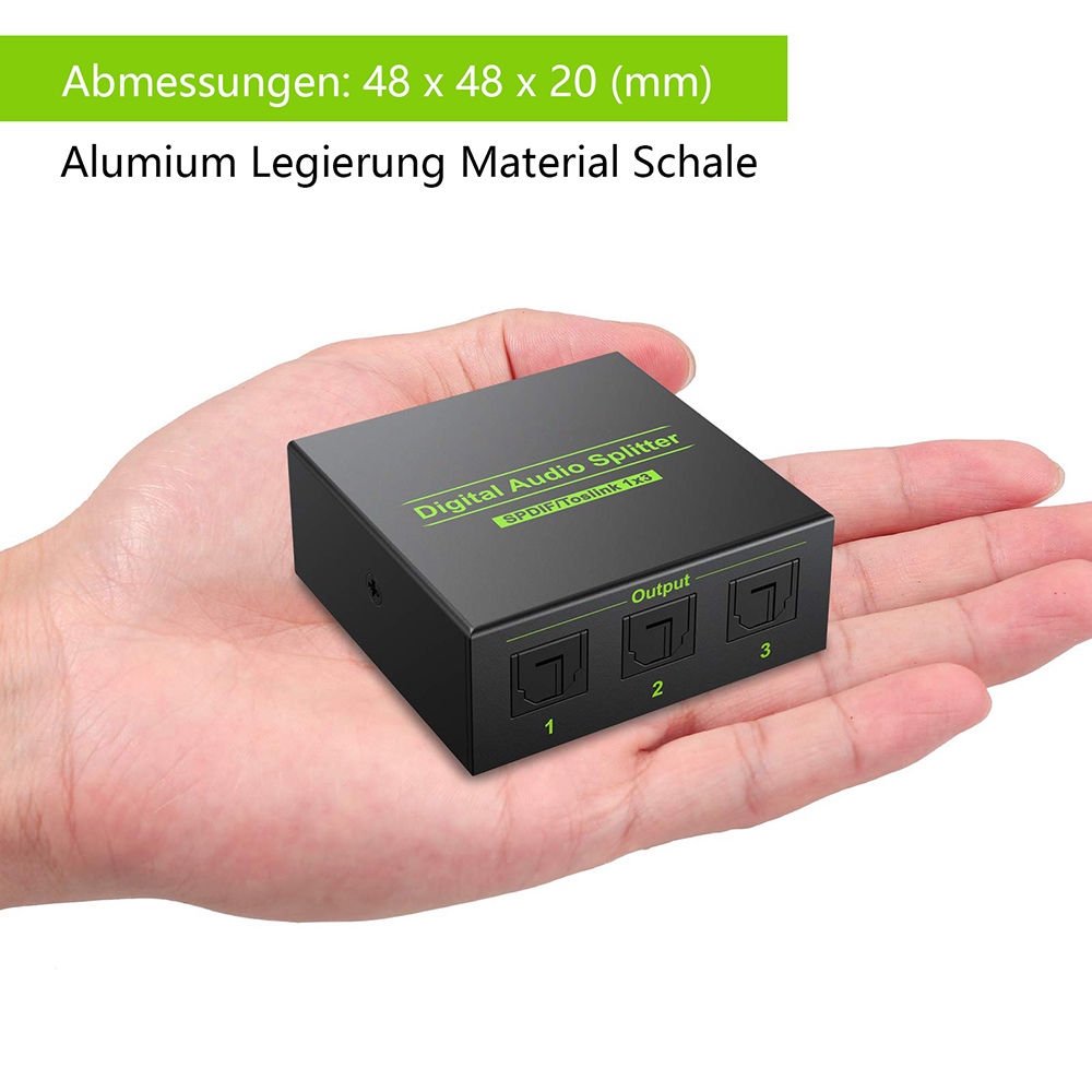 Digitaler Audio-Splitter in einer Hand gehalten. Das schwarze Gerät hat drei Ausgangsports, die mit 1, 2 und 3 beschriftet sind.