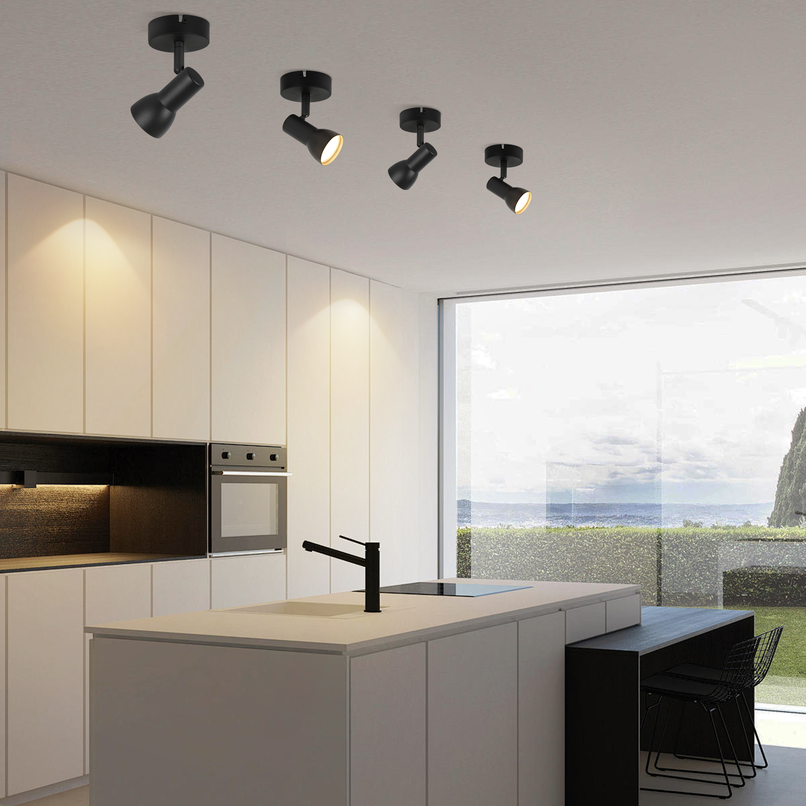 Cztery czarne reflektory sufitowe oświetlające kuchnię, z oknem i wyspą w tle.