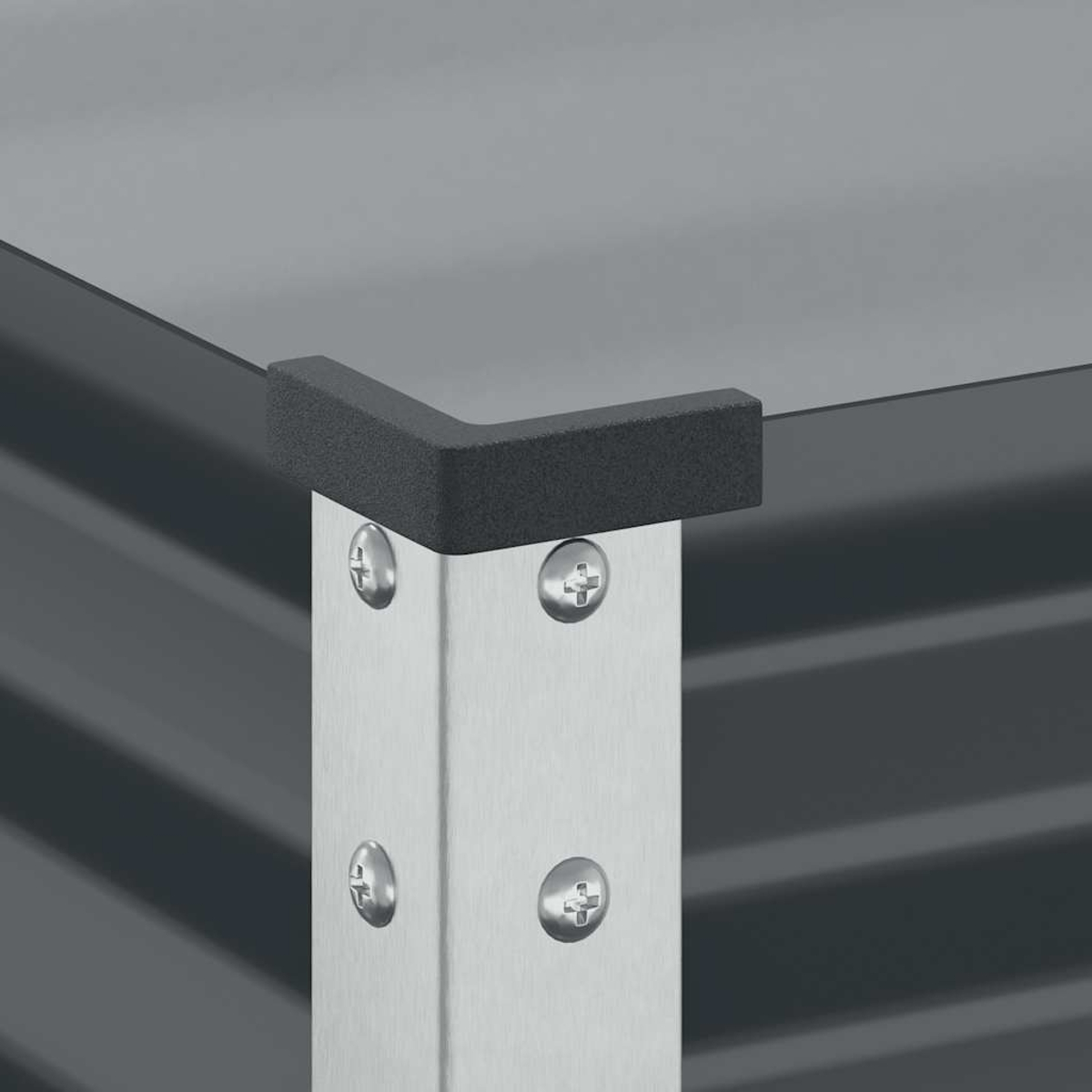 Un primo piano dell'angolo di una fioriera in metallo ondulato grigio con gambe argentate.