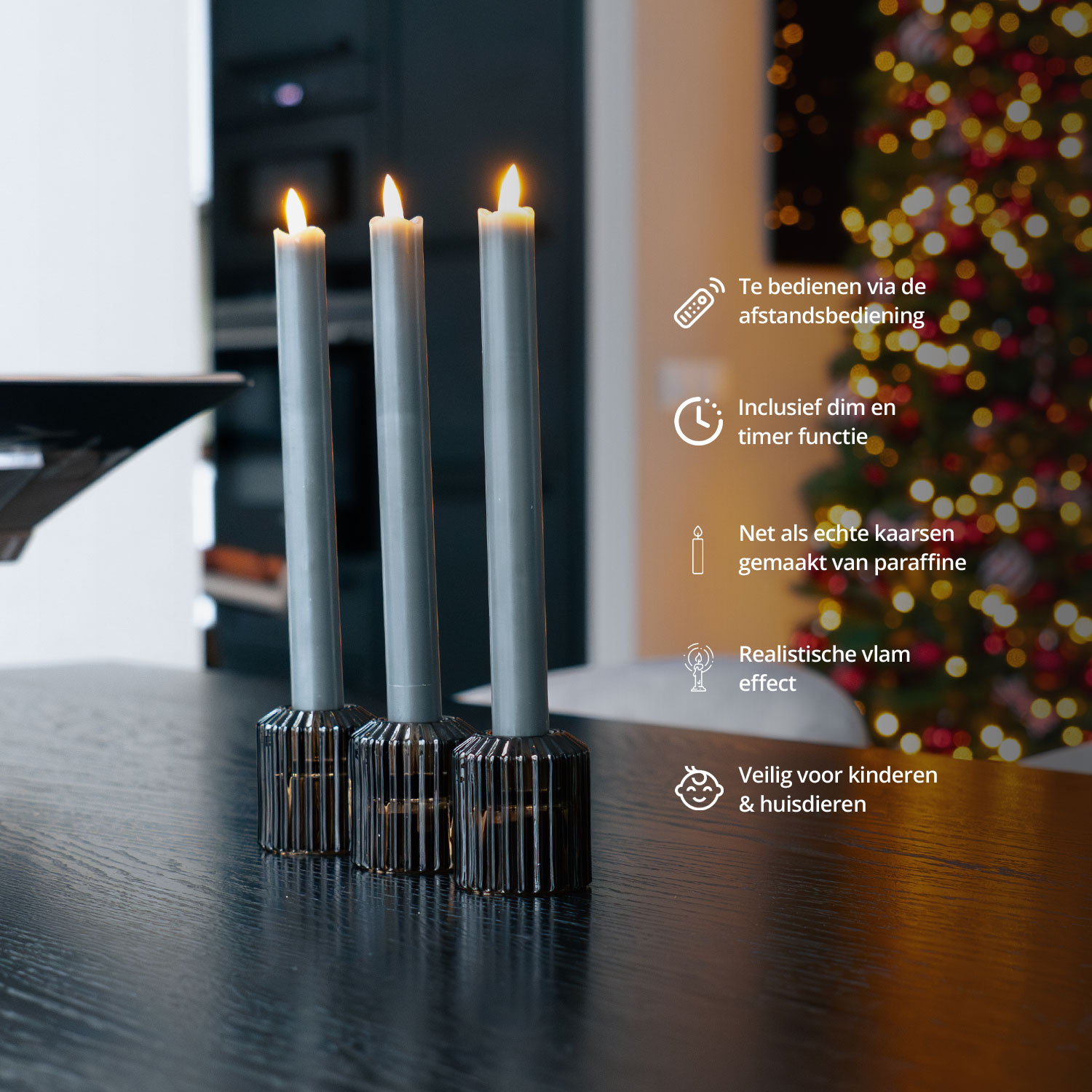 Three gray candles in black holders are displayed on a black table.