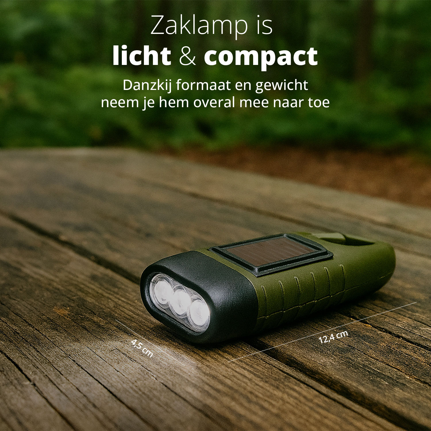 A compact, green hand-crank flashlight lies on a wooden surface, highlighting its lightweight and compact design.