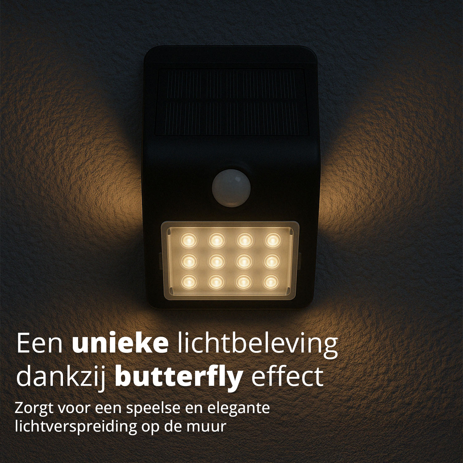Solar light on gray wall, creating a butterfly effect. Black with integrated solar panel and LED lights.