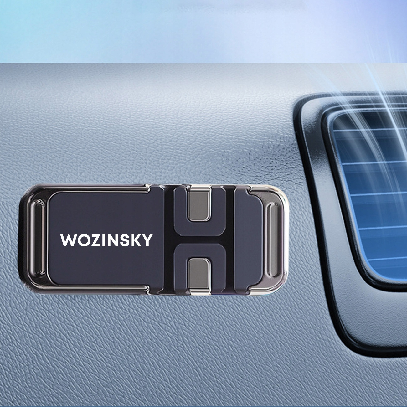 Czarny uchwyt na telefon w samochodzie. Uchwyt ma napis WOZINSKY.
