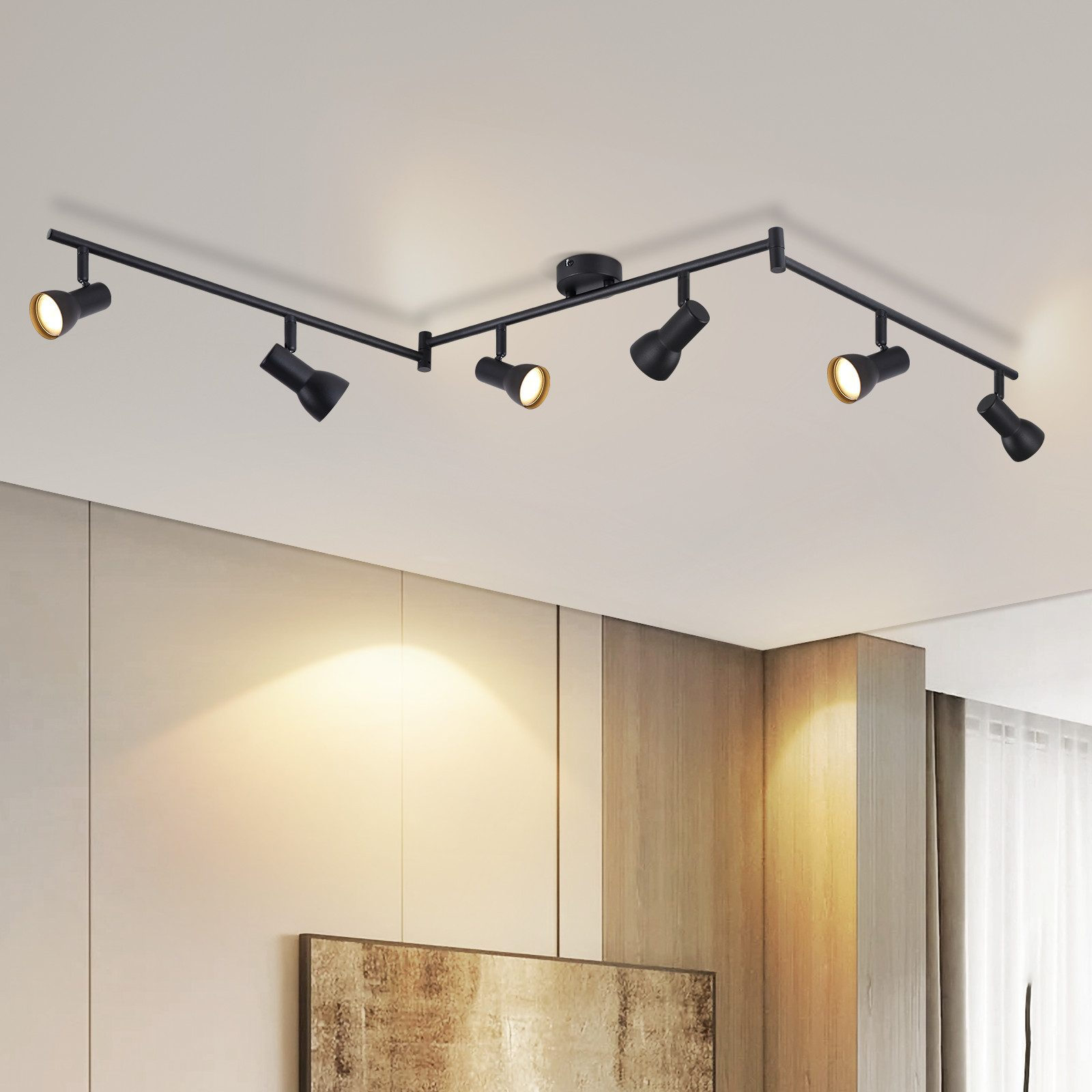 Un binario nero a zig-zag con sei faretti montati su un soffitto bianco.