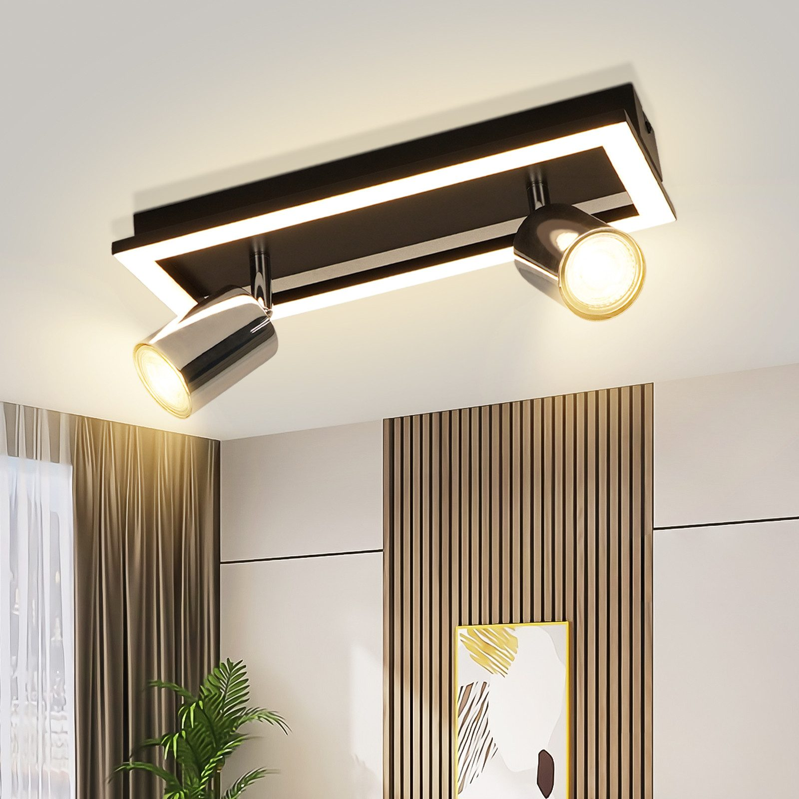 Un apparecchio per illuminazione a soffitto con due faretti. Il soffitto è di colore chiaro, con elementi decorativi.