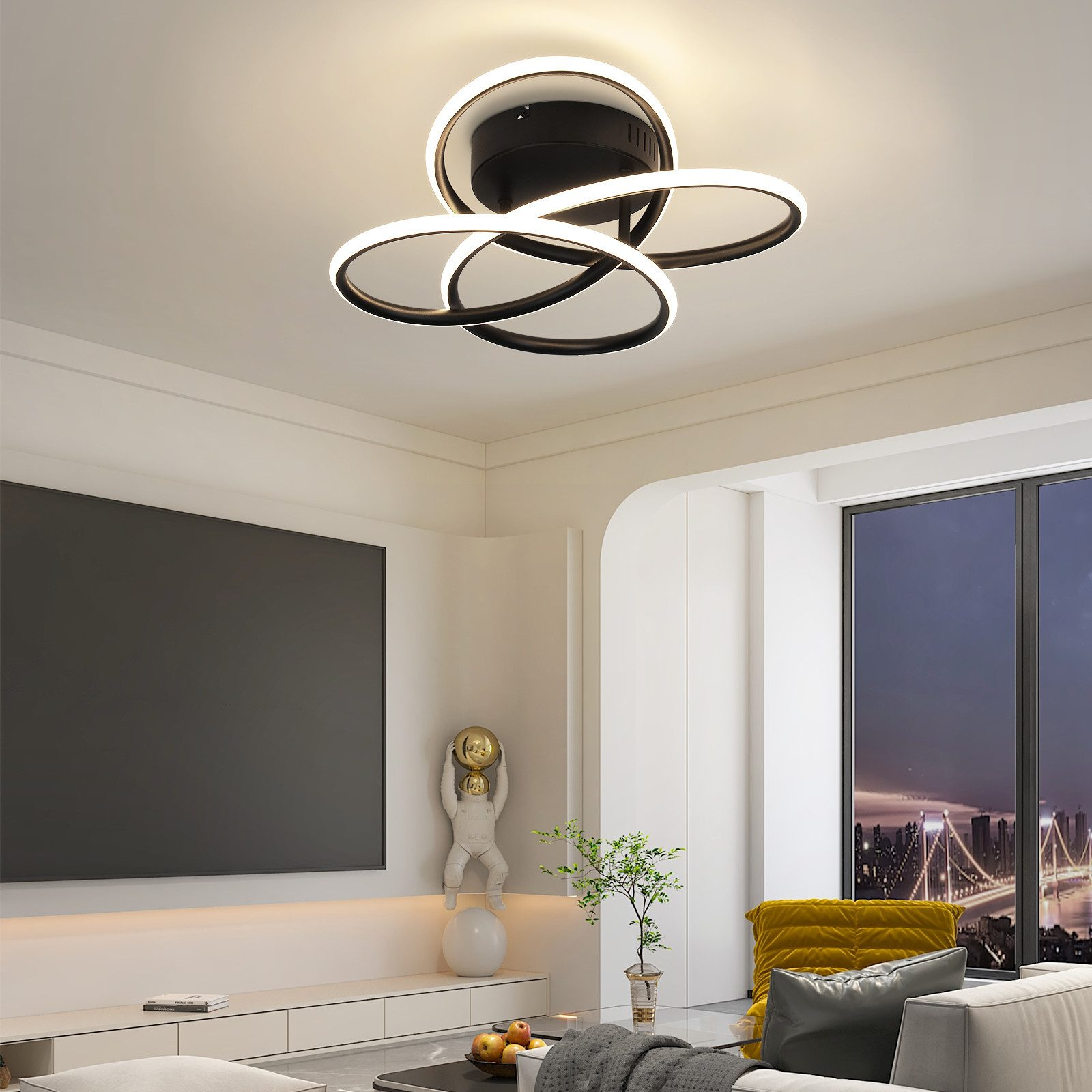 Una lámpara de techo moderna con tres luces LED circulares conectadas en un salón.