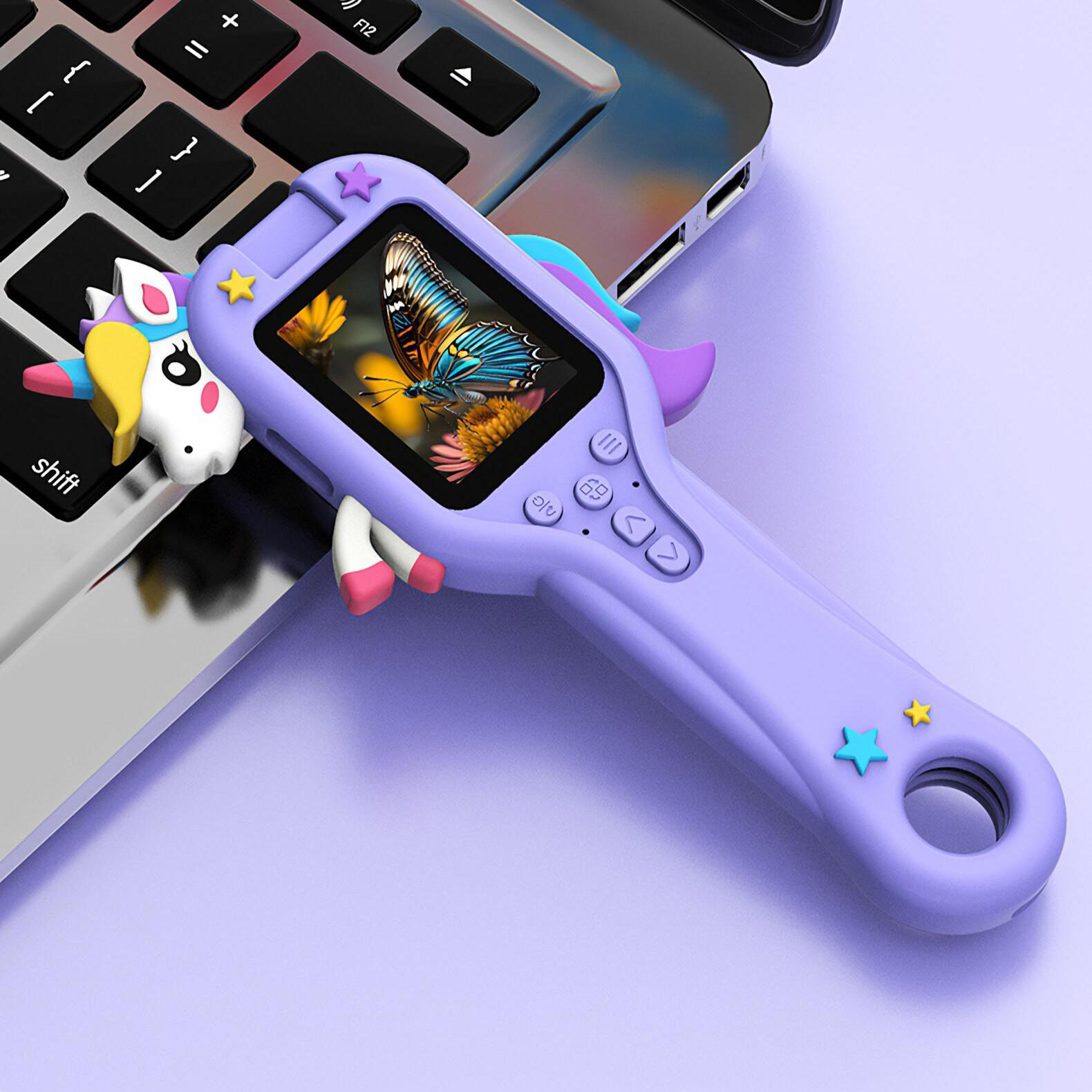Eine lila Kamera im Einhorn-Design, die ein Schmetterlingsbild anzeigt und auf der Tastatur eines Laptops liegt.