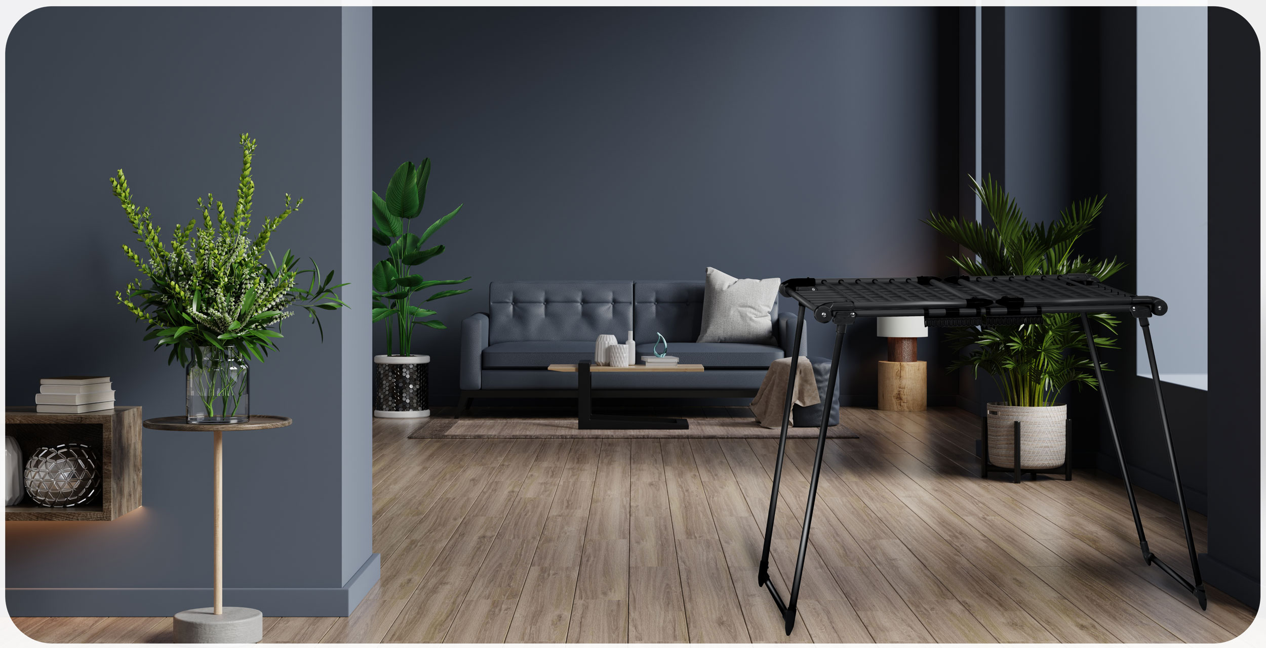 Czarna suszarka do ubrań jest ustawiona w pokoju z kanapą i roślinami.