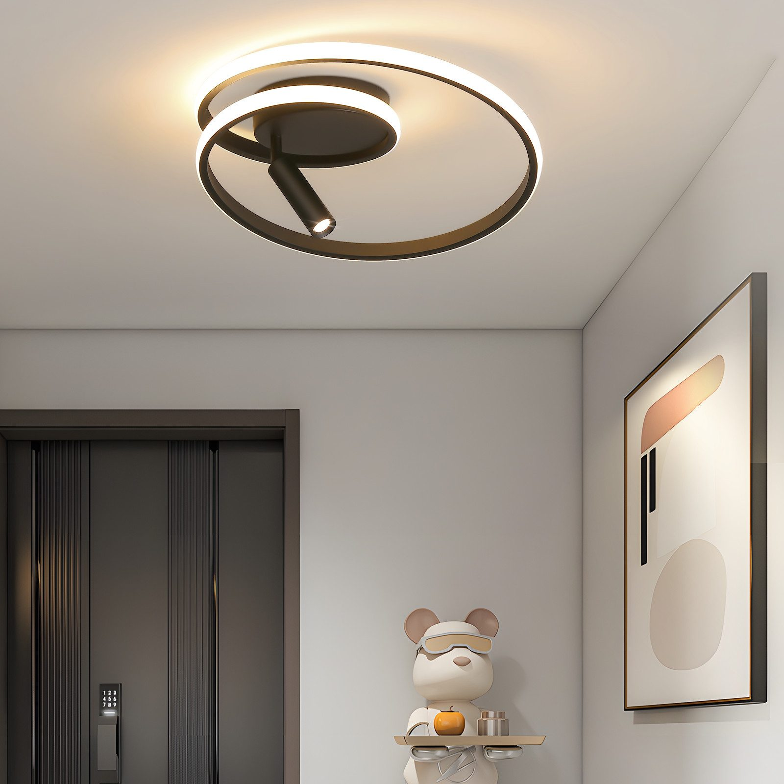Moderna plafoniera a LED a spirale in un corridoio con una porta nera ed elementi decorativi.