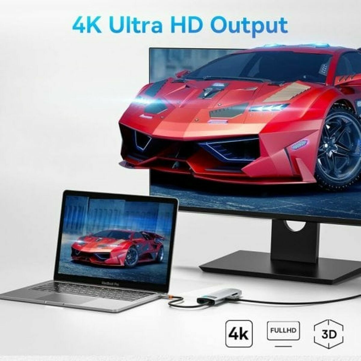 Laptop z samochodem na ekranie, podłączony do huba i monitor pokazujący ten sam samochód.