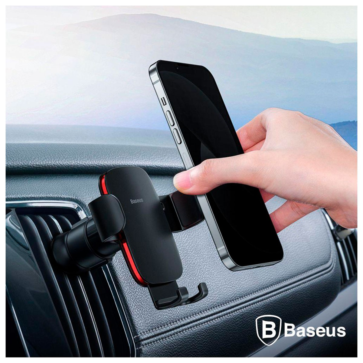 Ręka umieszcza telefon w uchwycie samochodowym Baseus przymocowanym do kratki wentylacyjnej w samochodzie.