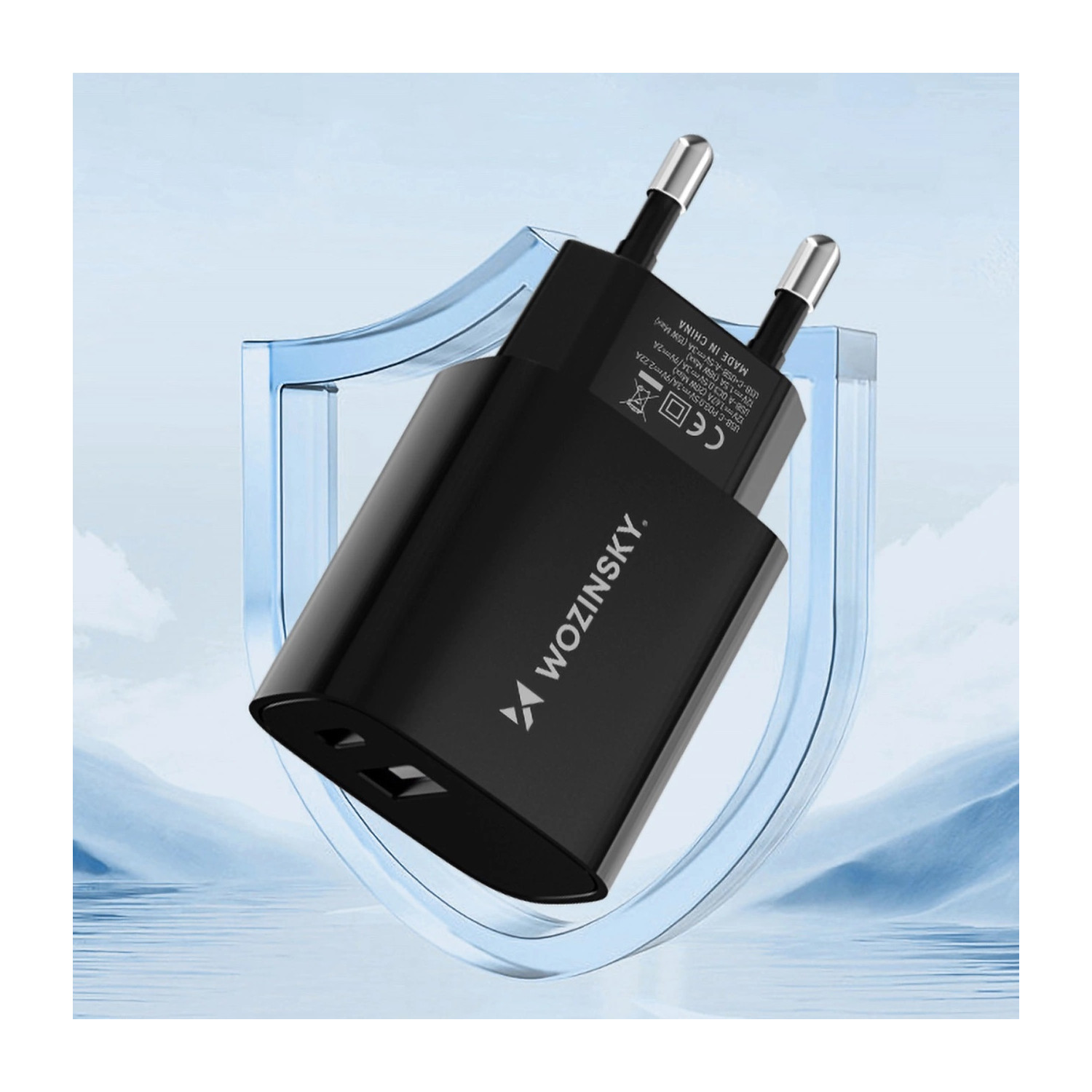 Czarna ładowarka Wozinsky, z pinami, w niebieskiej tarczy. Tekst 'Wozinsky' znajduje się na ładowarce.