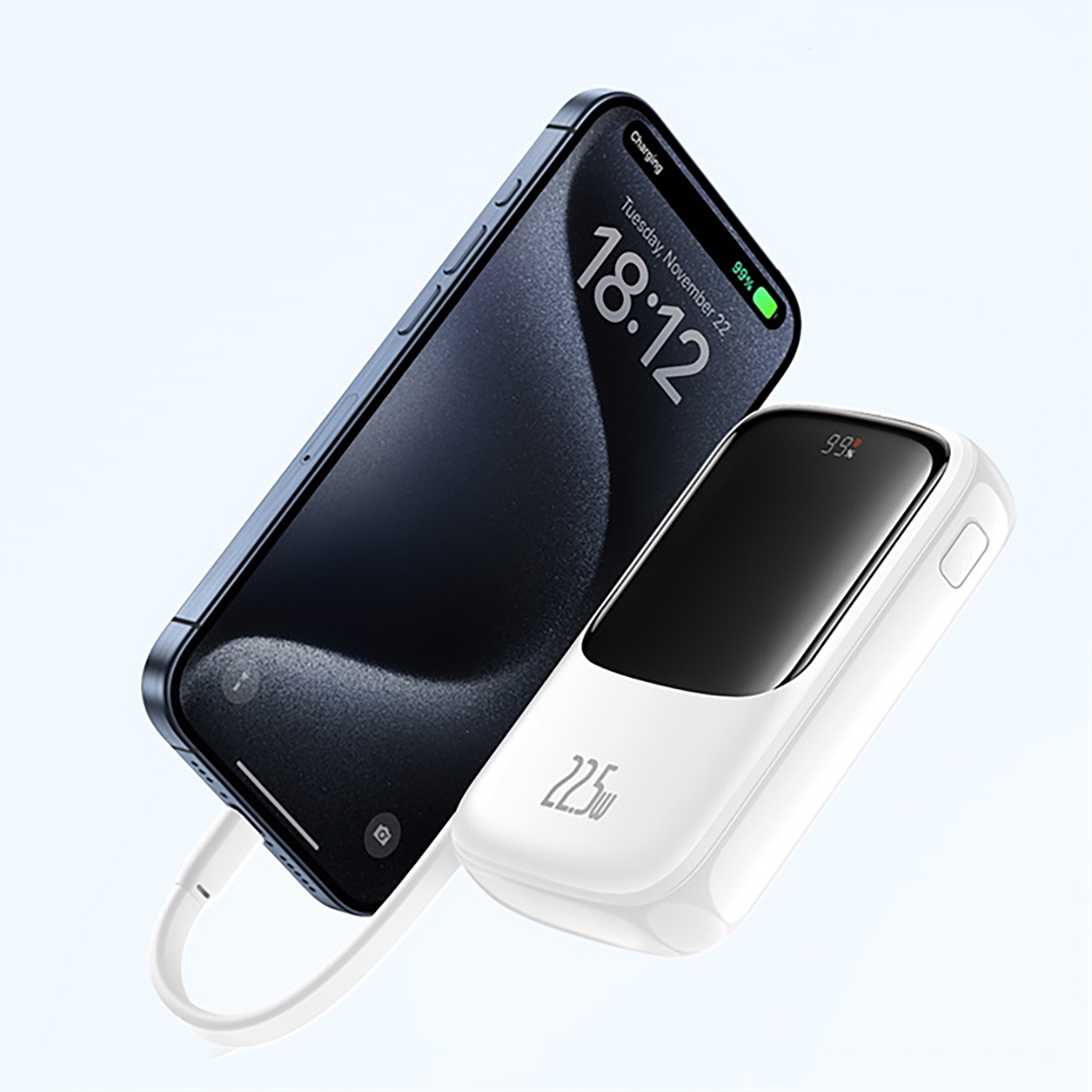 Telefon ładuje się za pomocą białego power banku. Telefon wyświetla datę i godzinę: wtorek, 22 listopada, 18:12.