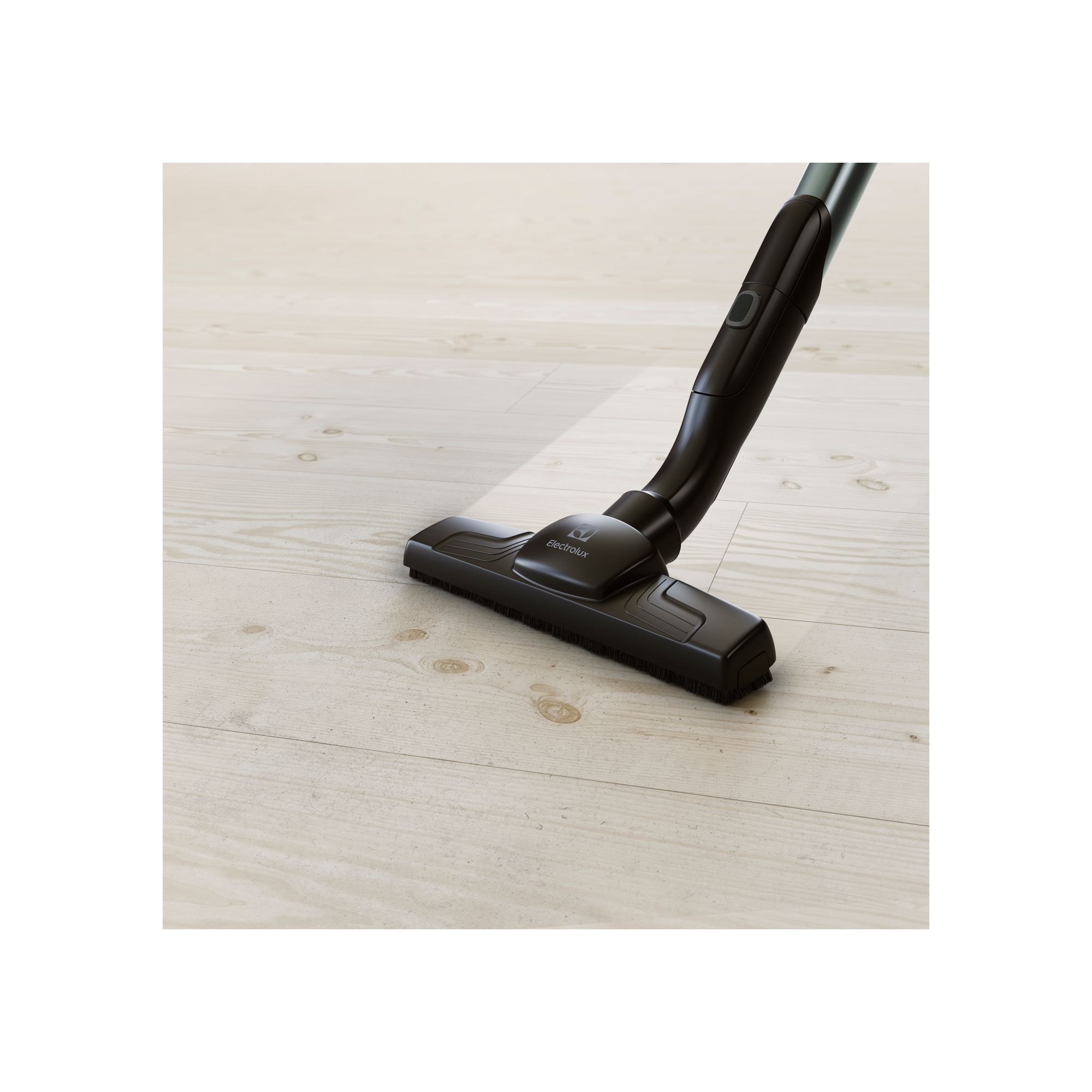 Una testina di aspirapolvere Electrolux nera è su un pavimento in legno bianco.