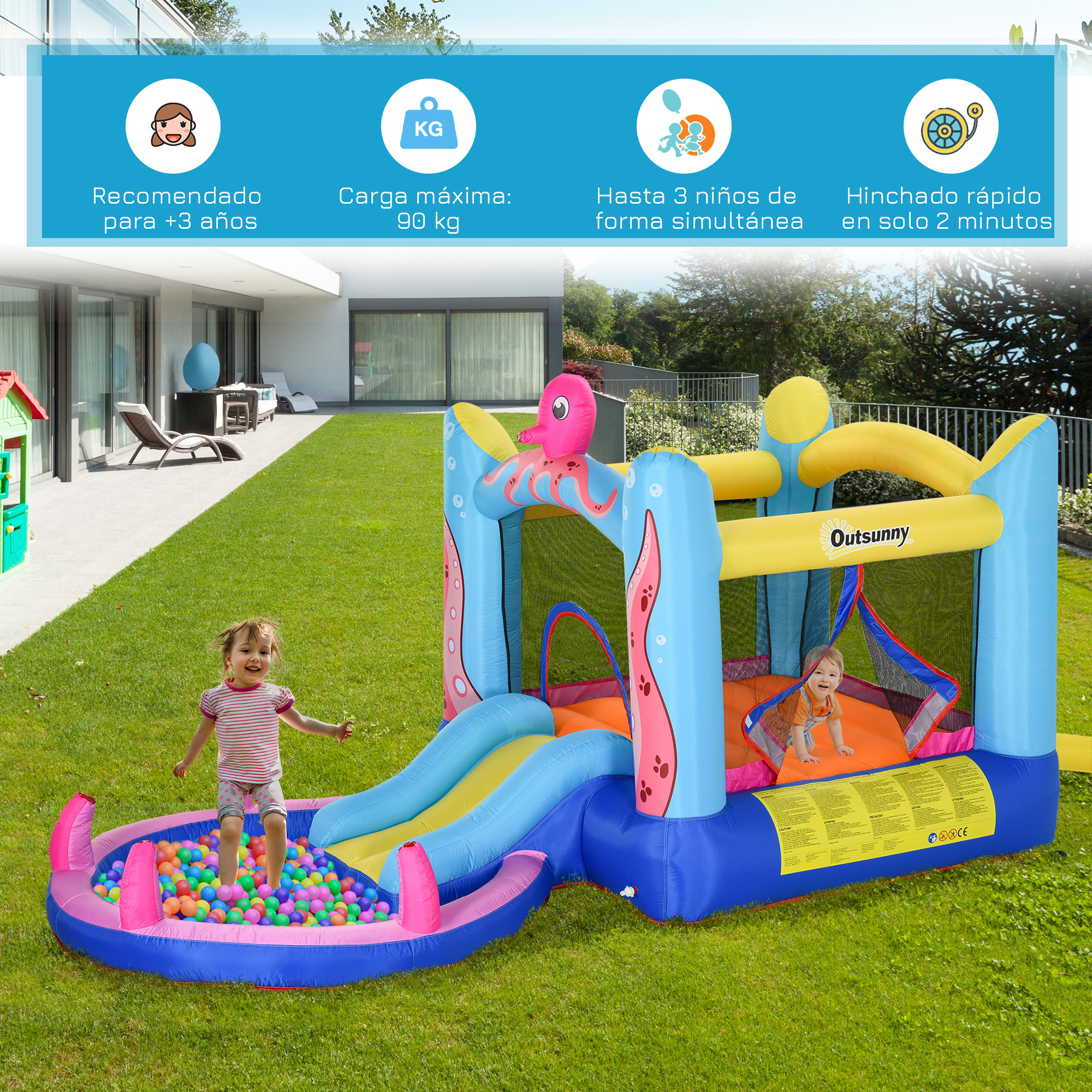 Castillo hinchable al aire libre con tobogán y piscina de bolas. Niños jugando en un jardín.