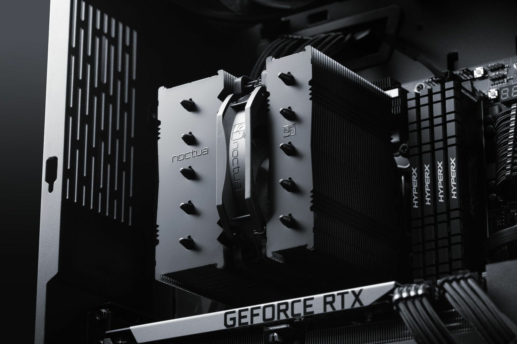 A close-up of a computer's internal components, including a CPU cooler and graphics card, on a dark background.