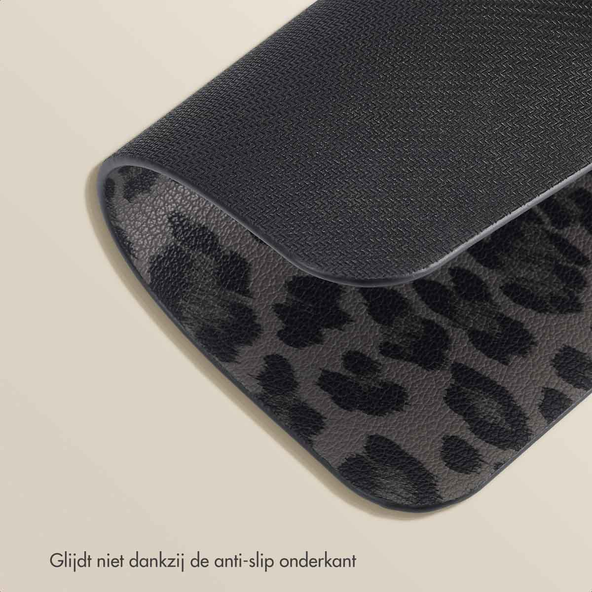 A leopard print mousepad with a black textured surface is shown at an angle on a light surface.