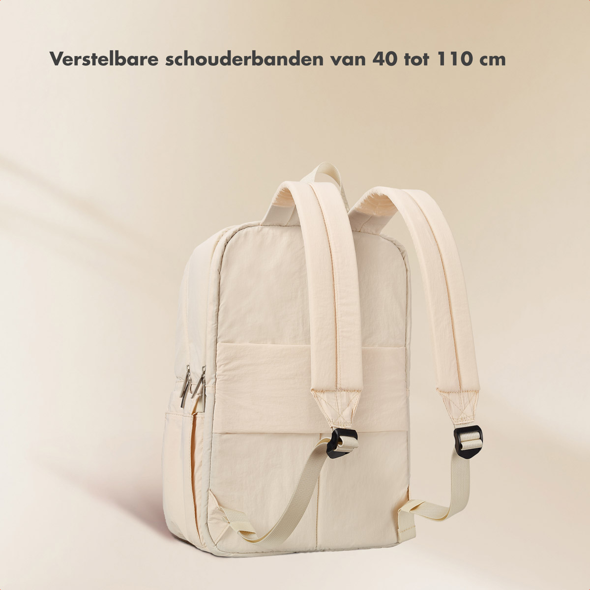 A beige backpack is displayed with adjustable shoulder straps, shown against a plain white background.