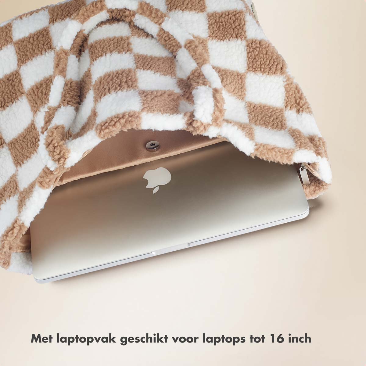 A checkered bag with a laptop inside. The bag is open, revealing the laptop.