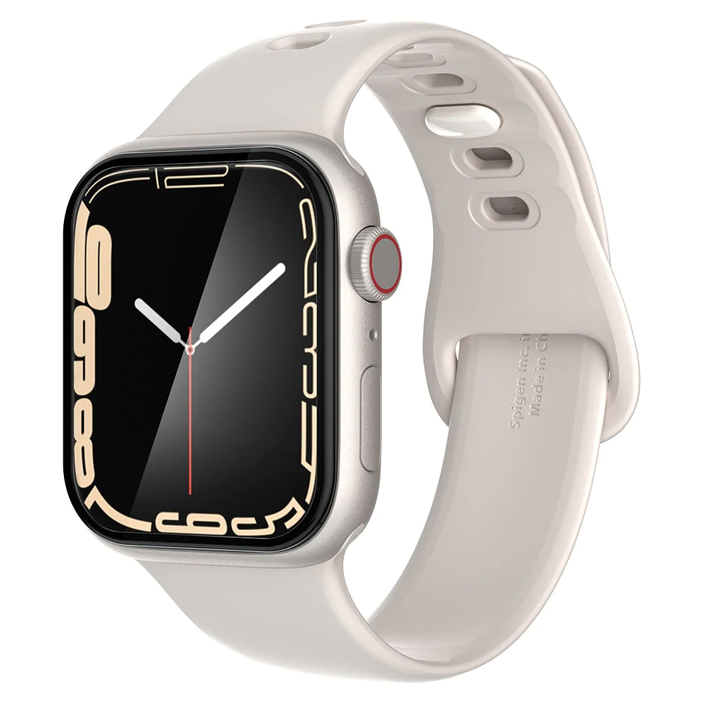 An Apple Watch with a white band. The watch has a black screen with gold numbers. The band has holes for ventilation.