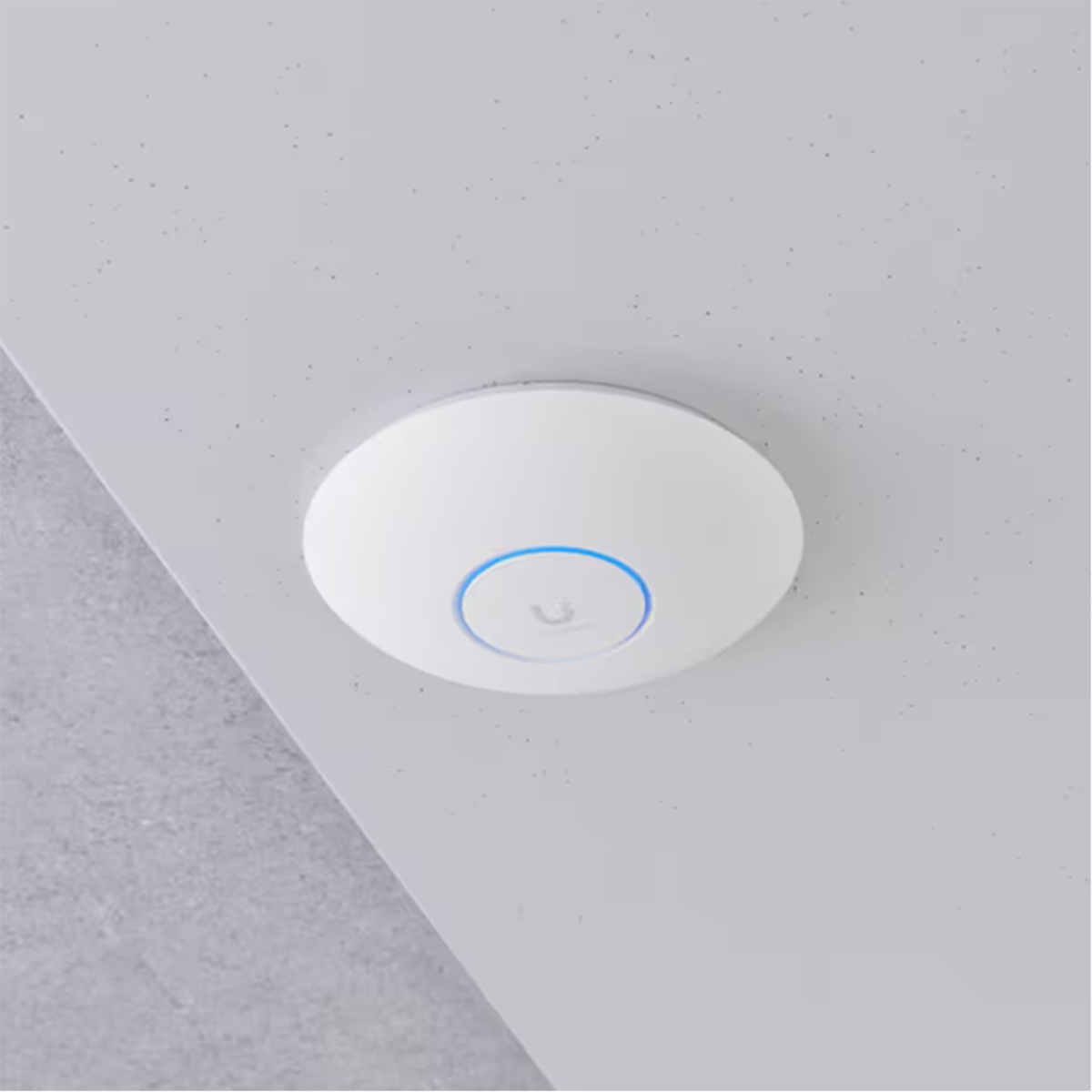 White round device mounted on a gray ceiling, featuring a blue light ring in the center.