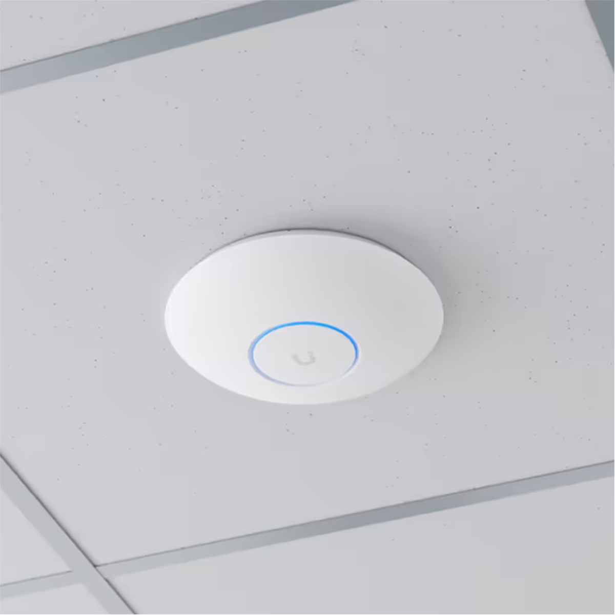 A white round device mounted on a ceiling with a blue light ring in the center.