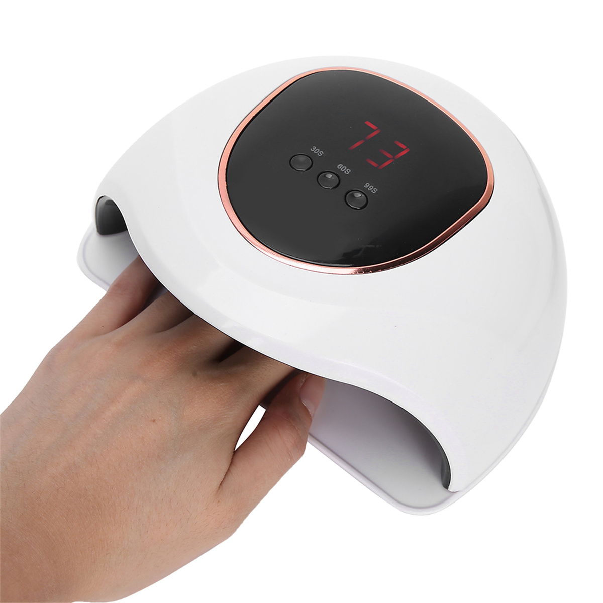 Eine Hand befindet sich in einer weißen und kupferfarbenen Nagellampe mit einer Digitaluhr, die „73“ anzeigt.