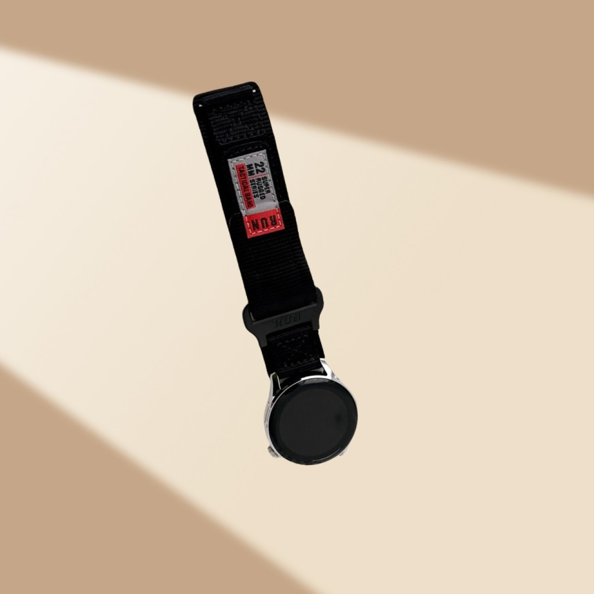 Un orologio con cinturino nero su sfondo marrone chiaro.