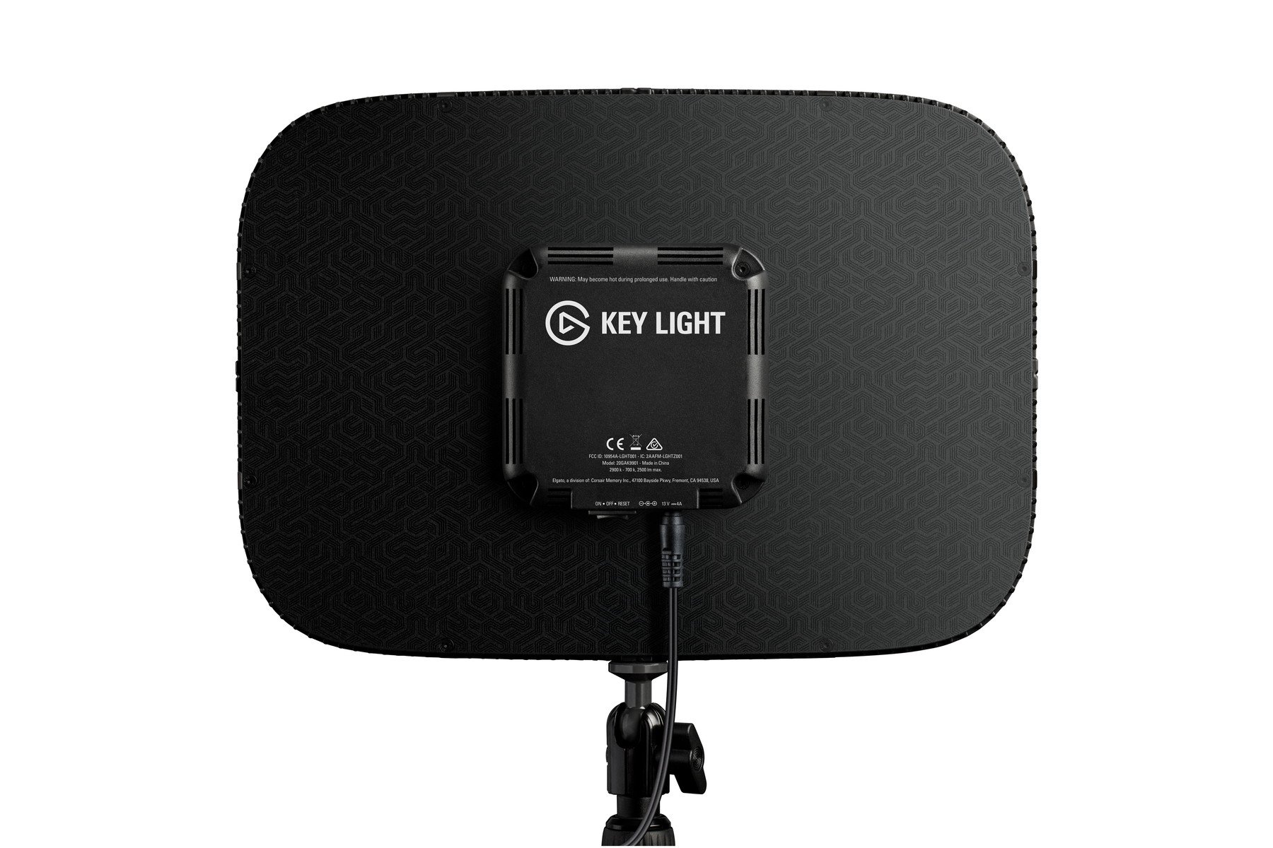 Il retro di una luce principale con una superficie nera modellata e il logo 'Key Light', montata su un supporto.